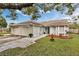 Charming single-story home with attached garages, complemented by a well-maintained lawn and tasteful landscaping at 7933 Merrimac Cove Dr, Orlando, FL 32822