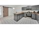 Modern kitchen features gray cabinets, stainless steel appliances, and a stylish barn door at 7933 Merrimac Cove Dr, Orlando, FL 32822
