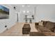 Inviting living room with an open floor plan, bar counter, and tile flooring at 7933 Merrimac Cove Dr, Orlando, FL 32822