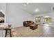 Open-concept living room leading to enclosed patio with tile flooring at 7933 Merrimac Cove Dr, Orlando, FL 32822