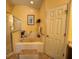 Main bathroom with soaking tub, shower and updated fixtures at 813 Halifax Dr, Kissimmee, FL 34758