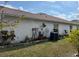 Back of the house with a satellite dish and AC unit at 813 Halifax Dr, Kissimmee, FL 34758