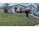 Single-story house with a green lawn and palm tree at 813 Halifax Dr, Kissimmee, FL 34758