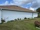 Side view of house showing landscaping and lawn at 813 Halifax Dr, Kissimmee, FL 34758
