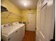 Functional laundry room, complete with washer, dryer, and shelving at 813 Halifax Dr, Kissimmee, FL 34758