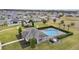 Aerial view of a community pool with lounge chairs and a playground surrounded by lush landscaping at 826 Birch Hollow Dr, Apopka, FL 32703