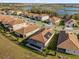Aerial view of homes with tile roofs in a beautiful neighborhood with a lake in the background at 8939 Fallen Oak Dr, Davenport, FL 33896