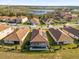 Aerial view of homes in the community, showing a serene lake in the background at 8939 Fallen Oak Dr, Davenport, FL 33896