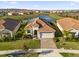 Aerial shot of a beautiful home with lake view and surrounding landscaping at 8939 Fallen Oak Dr, Davenport, FL 33896