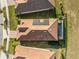 Aerial view of the home with a large backyard, screened in pool, and solar panels at 8939 Fallen Oak Dr, Davenport, FL 33896
