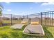 Inviting backyard featuring lounge chairs, a fence, and a scenic view of the neighborhood at 8939 Fallen Oak Dr, Davenport, FL 33896