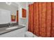 Bathroom with single sink vanity with decorative mirror and colorful shower curtain at 8939 Fallen Oak Dr, Davenport, FL 33896