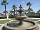 Beautiful tiered fountain with palm trees in the background offers a relaxing community gathering spot at 8939 Fallen Oak Dr, Davenport, FL 33896