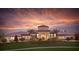 Stunning building with lush landscaping and a picturesque sunset backdrop, creating a serene and inviting atmosphere at 8939 Fallen Oak Dr, Davenport, FL 33896