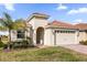 Charming home with a two-car garage, stone accents, and well-maintained landscaping at 8939 Fallen Oak Dr, Davenport, FL 33896