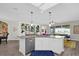 Open kitchen with an island, pendant lighting, and a view of the living room and backyard at 8939 Fallen Oak Dr, Davenport, FL 33896