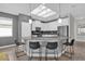 Bright kitchen with a skylight, an island with bar seating, and stainless steel appliances at 8939 Fallen Oak Dr, Davenport, FL 33896