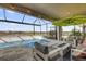 Enclosed lanai with in-ground pool, patio furniture, and lovely neighborhood views at 8939 Fallen Oak Dr, Davenport, FL 33896
