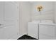 Functional laundry room with washer, dryer, and wire shelving at 8939 Fallen Oak Dr, Davenport, FL 33896