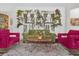 Cozy living room with plant wall feature, colorful furniture, and a shag rug at 8939 Fallen Oak Dr, Davenport, FL 33896
