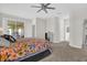 Spacious main bedroom with a sliding glass door to lanai and neutral carpeting at 8939 Fallen Oak Dr, Davenport, FL 33896