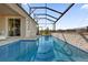 Beautiful in-ground screened-in pool with waterfall feature and a gorgeous view at 8939 Fallen Oak Dr, Davenport, FL 33896
