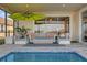 Covered patio with seating area next to the pool at 8939 Fallen Oak Dr, Davenport, FL 33896
