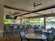 Outdoor poolside bar with seating, TV, and a view of the pool and surrounding greenery at 8939 Fallen Oak Dr, Davenport, FL 33896