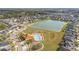 Aerial view of community pool and playground with mature landscaping near the houses at 947 Emerald Green Ct, Kissimmee, FL 34746
