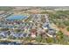 Aerial view of a well-planned community with homes, trees, and a serene lake at 947 Emerald Green Ct, Kissimmee, FL 34746