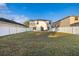 Extensive backyard with well-maintained lawn, white fence, and outdoor seating area at 947 Emerald Green Ct, Kissimmee, FL 34746