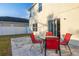 A backyard patio featuring red chairs and a table, perfect for outdoor relaxation at 947 Emerald Green Ct, Kissimmee, FL 34746