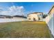 Large backyard with lush green grass, white fence, and patio seating area, perfect for entertaining at 947 Emerald Green Ct, Kissimmee, FL 34746