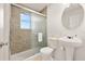 Bathroom with a bathtub-shower combo and a pedestal sink at 947 Emerald Green Ct, Kissimmee, FL 34746