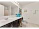 Well-lit bathroom with a vanity area, modern sink, and a decorative mirror at 947 Emerald Green Ct, Kissimmee, FL 34746