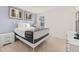 Cozy bedroom showcasing a full-size bed with a white metal frame, accented by framed artwork at 947 Emerald Green Ct, Kissimmee, FL 34746