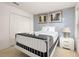 Comfortable bedroom with a full-size bed and a neutral color palette, featuring closet and artwork at 947 Emerald Green Ct, Kissimmee, FL 34746