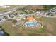 Aerial view of community pool and playground with mature landscaping and ample parking at 947 Emerald Green Ct, Kissimmee, FL 34746