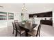 Open-concept dining area with a dark wood dining table and seating next to the kitchen at 947 Emerald Green Ct, Kissimmee, FL 34746