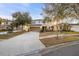 Inviting two-story home with a two-car garage, complemented by mature trees at 947 Emerald Green Ct, Kissimmee, FL 34746