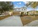Charming two-story home featuring a manicured lawn and a spacious driveway at 947 Emerald Green Ct, Kissimmee, FL 34746
