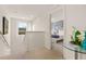Hallway leading to a bedroom, illuminated by natural light from a window at 947 Emerald Green Ct, Kissimmee, FL 34746