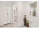 Hallway with tile flooring, closet, and a glimpse of a bathroom at 947 Emerald Green Ct, Kissimmee, FL 34746