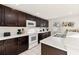 Well-equipped kitchen with sleek, dark cabinetry and bright white countertops for a modern look at 947 Emerald Green Ct, Kissimmee, FL 34746