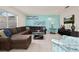 Inviting living room with plush brown sectional sofa and large window for ample natural light at 947 Emerald Green Ct, Kissimmee, FL 34746