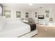 Stylish bedroom with seating area, a bed and a modern dresser with television at 947 Emerald Green Ct, Kissimmee, FL 34746