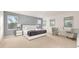 Spacious bedroom with multiple windows, a sleek bed, seating area and contemporary decor at 947 Emerald Green Ct, Kissimmee, FL 34746