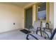 Covered front porch with seating and a charming entry door at 947 Emerald Green Ct, Kissimmee, FL 34746
