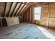 Unfinished attic under construction with exposed wood beams and flooring and a window at 0 Orangewood Ave, St Cloud, FL 34772