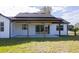 Exterior of home with large glass doors to backyard patio with a black roof at 0 Orangewood Ave, St Cloud, FL 34772